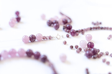 Preparing gemstone jewelry. Natural stones pink quartz, Amethyst, silver. Craft, handmade conception. Free space for text.