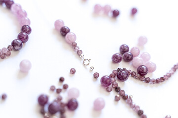 Preparing gemstone jewelry. Natural stones pink quartz, Amethyst, silver. Craft, handmade conception. Free space for text.
