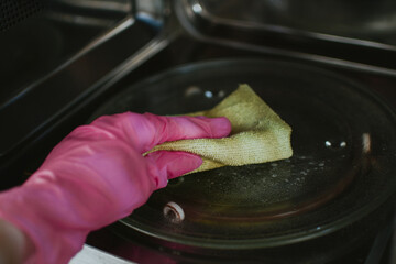 Cleaning the microwave with detergent and a cloth