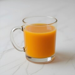 Glass cup filled with orange juice on a white background.