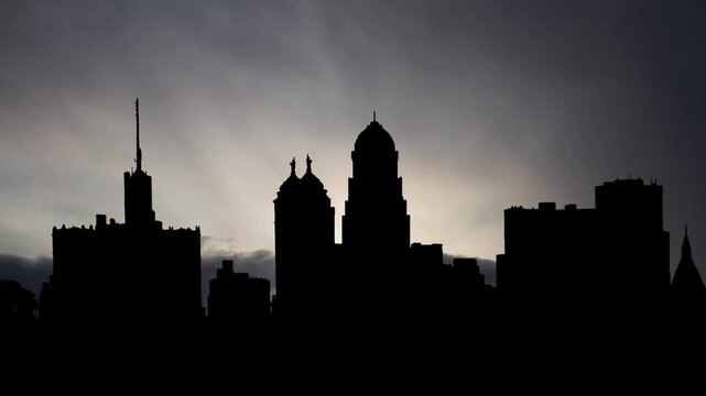 Silhouette of Buffalo Skyline at Sunrise, Time Lapse with Fast Clouds and Dark Silhouettete of the iconic Buffalo City Hall, New York, USA