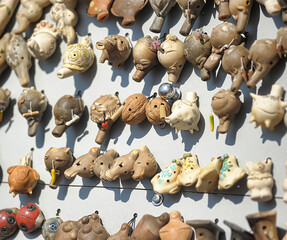 a collection of small ceramic whistles made in the form of various animals and mythical creatures.  