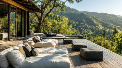 Obraz premium A lavish outdoor lounge area on a mountain terrace, featuring plush seating and sweeping views of the green valleys below.