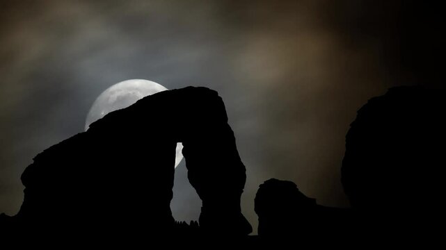 Elephant rock erosion monolith standing in the night desert, Time Lapse with Full Moon, Al Ula, Saudi Arabia