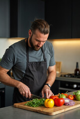 Fototapeta premium Bearded man chopping fresh vegetables.