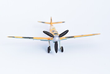 Plastic toy, completed and painted model for gluing. Historical German plane Messerschmitt BF109 E.