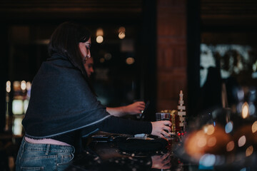 Woman enjoying a drink at a cozy night bar setting