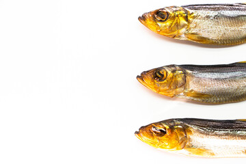 Hot smoked whole herrings on kitchen table. smoked fish isolated on white