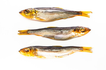 Hot smoked whole herrings on kitchen table. smoked fish isolated on white