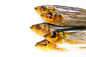 Hot smoked whole herrings on kitchen table. smoked fish isolated on white