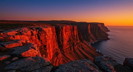 Fototapeta premium Stunning sunset illuminating majestic cliffs by the ocean
