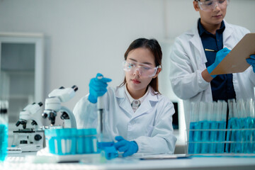 Scientific laboratory scene: researchers examining molecular samples, wearing protective gear,...