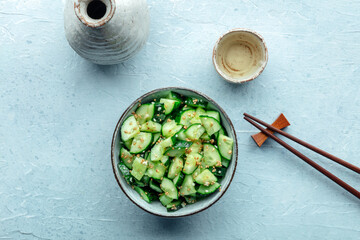 Smashed cucumber salad, healthy vegan food, green plant-based appetizer, overhead flat lay shot...