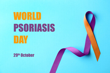 World Psoriasis Day (October, 29). Orange-orchid awareness ribbon on light blue background, top view
