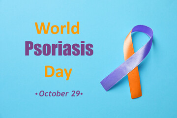 World Psoriasis Day (October, 29). Orange-orchid awareness ribbon on light blue background, top view