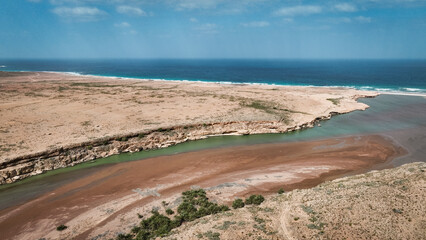 Breathtaking view of the coastline and river merging on Socotra Island during a sunny day