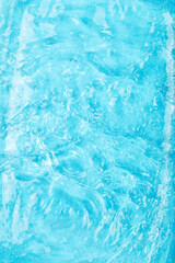 Vibrant blue water with rippling waves and light reflections creating dynamic and refreshing...