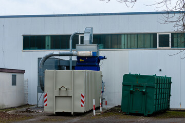 Industrial machinery working behind a factory building