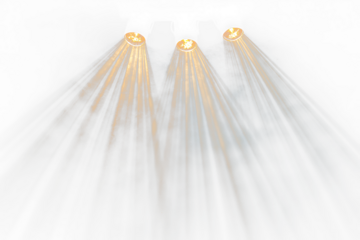 Three spotlights illuminate a Transparent stage with beams of light.