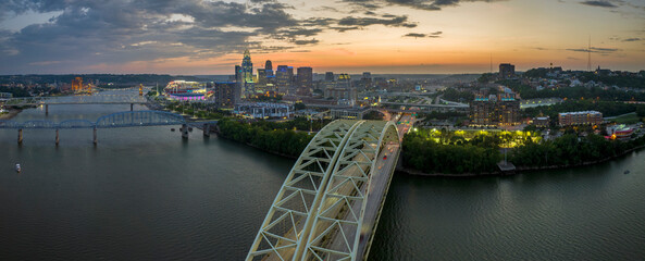 Aerial view of downtown district highway traffic in Cincinnati city, Ohio at night. Brightly...