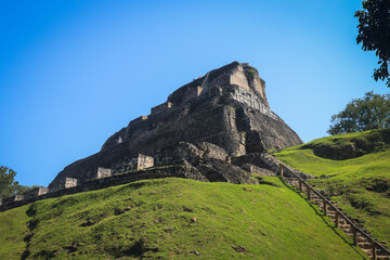 Explore Xunantunich Mayan ruins in Belize under clear blue skies and lush green landscapes