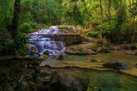 Serene waterfall in lush forest - Powered by Adobe