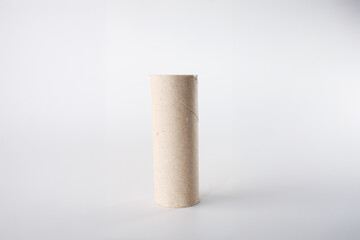 Light brown cardboard tube, a common household item, standing upright. Ideal for businesses promoting recycling, upcycling, or crafting tutorials using everyday objects for creative projects