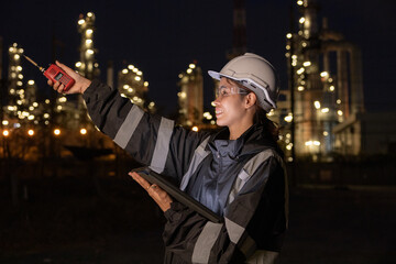 Fototapeta premium Engineers Conducting Night Inspection at Refinery