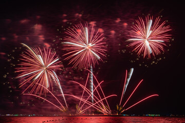 Multicolored Fireworks Exploding Over Water