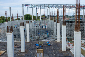Steel roof structure, high scaffolding, preparing to pour concrete floor and cement pillars © Washburn