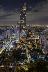 Fototapeta premium High angle view of beautiful building. Aerial view from above of Thailand with long exposure car traffic.