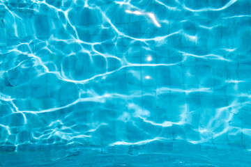 Blue Water Pool Surface with Sunlight Reflections