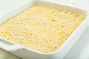 A cake from a sandy crust into a forming form