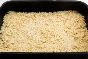 A cake from a sandy crust into a forming form