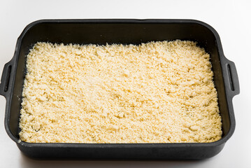 A cake from a sandy crust into a forming form