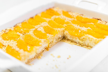 Pie with a sandy crumb with oranges in a forming form