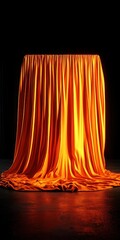 An orange silk cloth dramatically draped over an unseen object  set against a dark background