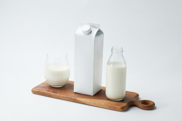 Milk Carton and Glasses on Wooden Tray Showcasing Fresh Dairy Products on a Minimal Background