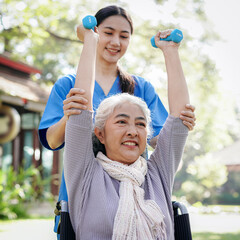 A woman in a wheelchair is being assisted by a woman in a blue shirt