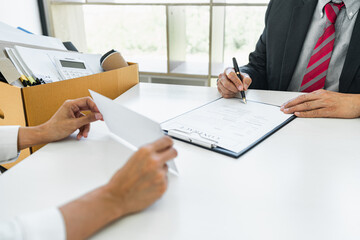 Image of business woman hand sending a resignation letter to his boss, change of job, unemployment, resign concept