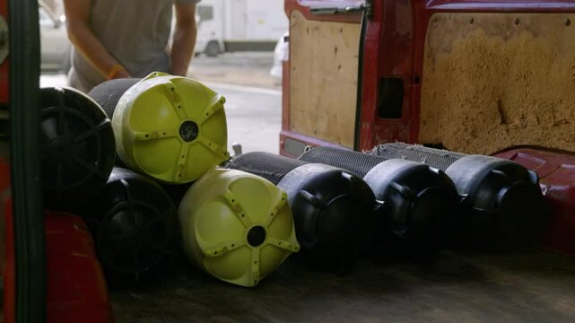 Scuba tanks loaded into van: View inside a van with multiple dive cylinders, showcasing equipment transportation for a diving trip