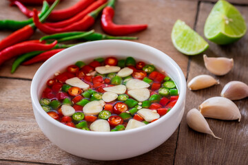 Chili with fish sauce in white bowl..