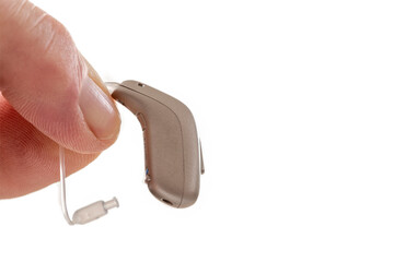 Hand holding a hearing aid device with a thin wire