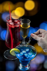 Pouring substance into colorful cocktail glass
