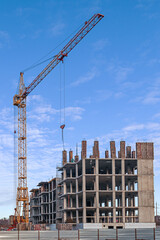 Construction site of a modern building with a crane and blue sky
