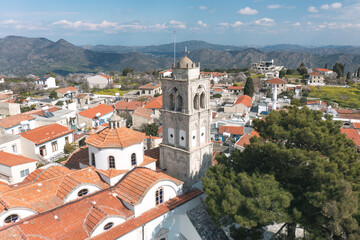 Obraz premium Aerial view of Pano Lefkara village in Cyprus, showcasing traditional architecture, red-tiled roofs, and surrounding mountainous landscape. Larnaca District