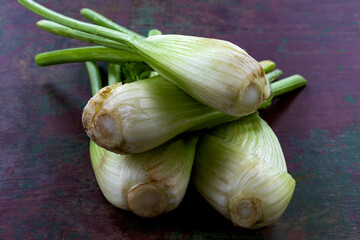 Fresh scallions gathered on a wooden table