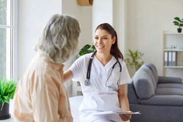 Doctor, young nurse consulting senior female patient supporting, helping sharing results, medical...
