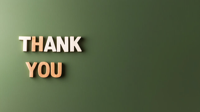 Wooden letters spelling Thank You on a green background. Showing appreciation. Gratitude concept with copy space to the side for additional text.