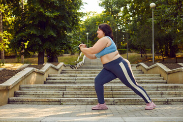 Overweight fat young woman wearing sportswear doing sport fit exercises in the summer city park....